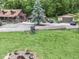 Wide shot of the property featuring the log cabin, garage, and lush lawn at 5240 W 400 N, Fairland, IN 46126