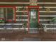 Inviting front porch featuring rustic decor, a seating area, and a charming welcome sign at 5240 W 400 N, Fairland, IN 46126