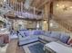 Open-concept living room featuring wood paneling, vaulted ceilings, and a view of the dining area at 5240 W 400 N, Fairland, IN 46126
