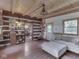 Comfortable living room with exposed beams, cozy seating, and access to an outdoor porch at 5240 W 400 N, Fairland, IN 46126