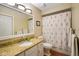Clean bathroom featuring a vanity with granite counters and a tub with a floral shower curtain at 526 W Hunters Dr # C, Carmel, IN 46032