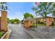 Inviting community entrance featuring a brick guard house and mature trees, creating a welcoming atmosphere at 526 W Hunters Dr # C, Carmel, IN 46032