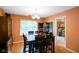 Traditional dining room featuring wood floors, a window with blinds, and access to an adjacent kitchen area at 526 W Hunters Dr # C, Carmel, IN 46032