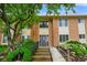 Charming brick condo exterior with well-maintained landscaping and accessible ramp to the front door at 526 W Hunters Dr # C, Carmel, IN 46032