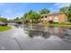 Exterior view of condo complex featuring covered parking, lush landscaping, and ample parking space for residents and guests at 526 W Hunters Dr # C, Carmel, IN 46032