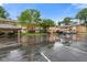 Exterior view of condo complex featuring covered parking, lush landscaping, and ample parking space for residents and guests at 526 W Hunters Dr # C, Carmel, IN 46032