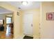 Entryway into home featuring tile floor, white door, and view into living room at 526 W Hunters Dr # C, Carmel, IN 46032