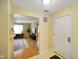 Entryway into home featuring tile floor, white door, and view into living room at 526 W Hunters Dr # C, Carmel, IN 46032