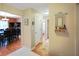 Hallway leading to a dining area with a black dining set and wood flooring at 526 W Hunters Dr # C, Carmel, IN 46032