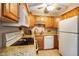 Kitchen with granite countertops, wood cabinets, and stainless steel appliances at 526 W Hunters Dr # C, Carmel, IN 46032