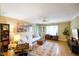 Bright living room featuring hardwood floors, a comfortable white sofa, and natural light from a large window at 526 W Hunters Dr # C, Carmel, IN 46032