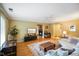 Bright living room with hardwood floors, ceiling fan, and an inviting fireplace at 526 W Hunters Dr # C, Carmel, IN 46032