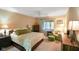 Spacious main bedroom with comfortable seating area, ceiling fan, and ample natural light at 526 W Hunters Dr # C, Carmel, IN 46032