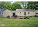 View of home's backyard with grass, brick patio, and outdoor seating at 5378 Rosslyn Ave, Indianapolis, IN 46220