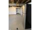 The unfinished basement includes a stainless steel refrigerator at 5378 Rosslyn Ave, Indianapolis, IN 46220