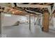 Unfinished basement with exposed ceiling beams and brick accent column at 5378 Rosslyn Ave, Indianapolis, IN 46220