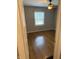 An empty bedroom featuring shiny hardwood floors, ceiling fan, and neutral wall paint at 5378 Rosslyn Ave, Indianapolis, IN 46220