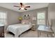 Comfortable bedroom features a full-size bed, desk, and ample natural light from two windows at 5378 Rosslyn Ave, Indianapolis, IN 46220