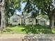Charming bungalow with well-kept lawn and mature trees providing ample shade at 5378 Rosslyn Ave, Indianapolis, IN 46220