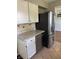 This kitchen features stainless steel appliances, white cabinets, and stylish backsplash at 5378 Rosslyn Ave, Indianapolis, IN 46220