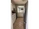 Well-lit kitchen featuring white cabinets, tile floors, and stainless steel appliances at 5378 Rosslyn Ave, Indianapolis, IN 46220