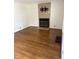 Bright living room featuring gleaming hardwood floors and a modern tiled fireplace at 5378 Rosslyn Ave, Indianapolis, IN 46220