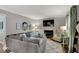 Comfortable living room with a stone fireplace, large sectional sofa, and modern decor at 5378 Rosslyn Ave, Indianapolis, IN 46220