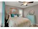 Cozy bedroom with a queen-size bed, stylish decor, and a ceiling fan for added comfort at 5378 Rosslyn Ave, Indianapolis, IN 46220