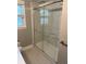 Bathroom featuring glass-enclosed shower with marble-patterned tile and modern fixtures at 5378 Rosslyn Ave, Indianapolis, IN 46220