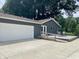 View of backyard with accessible ramp, patio, large garage and mature landscaping at 540 Lazy Ln, Greenwood, IN 46142
