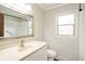 This bathroom features a sink with a stainless steel faucet, a large mirror, and natural light at 540 Lazy Ln, Greenwood, IN 46142