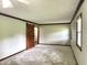 Large bedroom featuring neutral carpet, wood trim and a stylish sliding barn door at 540 Lazy Ln, Greenwood, IN 46142