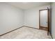 This bedroom features neutral carpet and paint, and the entry to another room at 540 Lazy Ln, Greenwood, IN 46142