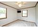 This bedroom features neutral carpet, and is equipped with a ceiling fan and a tv mounted on the wall at 540 Lazy Ln, Greenwood, IN 46142