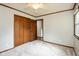 This bedroom features neutral carpet, a large window, and a closet with standard hinged doors at 540 Lazy Ln, Greenwood, IN 46142