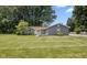 Charming single-story home showcasing its well-manicured lawn and inviting yellow front door at 540 Lazy Ln, Greenwood, IN 46142