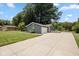 Charming single-story home with gray brick, well-manicured lawn, and extended concrete driveway at 540 Lazy Ln, Greenwood, IN 46142