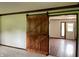 View of an open doorway with a sliding barn door and view to the front entrance of the home at 540 Lazy Ln, Greenwood, IN 46142