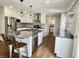 Bright kitchen with stainless steel appliances, gray backsplash, and granite countertops at 540 Lazy Ln, Greenwood, IN 46142