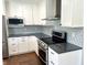View of stainless steel appliances and modern cabinetry and tiling at 540 Lazy Ln, Greenwood, IN 46142
