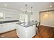 Bright kitchen with white cabinets, gray counters, and island seating perfect for entertaining at 540 Lazy Ln, Greenwood, IN 46142