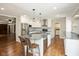 Modern kitchen with stainless appliances, granite counters, island with seating, and white cabinetry at 540 Lazy Ln, Greenwood, IN 46142