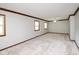This room features neutral colored walls and carpet, trimmed windows, and a sliding barn door at 540 Lazy Ln, Greenwood, IN 46142