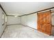 This room features neutral colored walls and carpet, trimmed windows, and a sliding barn door at 540 Lazy Ln, Greenwood, IN 46142