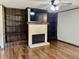 Inviting living room with a fireplace, a wall mounted television, and beautiful hardwood floors at 540 Lazy Ln, Greenwood, IN 46142