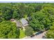 Aerial shot showcases property amidst lush trees, highlighting neighborhood and curb appeal at 5424 Broadway St, Indianapolis, IN 46220