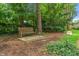 Backyard wooden bench seating area shaded by trees in a serene outdoor space at 5424 Broadway St, Indianapolis, IN 46220