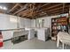 Unfinished basement with washer, dryer, and sink at 5424 Broadway St, Indianapolis, IN 46220
