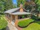 Attractive craftsman-style home with inviting front porch, brick facade, and manicured lawn at 5424 Broadway St, Indianapolis, IN 46220