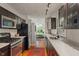 A well-lit kitchen featuring dark wood cabinetry, stainless steel appliances, and view into the adjacent living room at 5424 Broadway St, Indianapolis, IN 46220